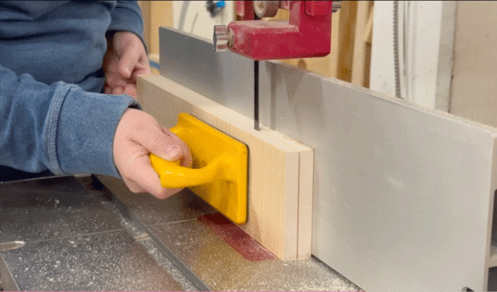 Amanda resaws a board at the bandsaw. 