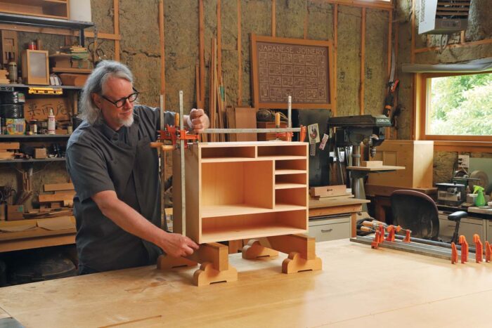 A completed tansu carcase with four clamps on it.