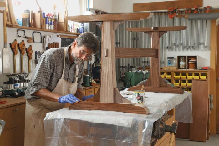 Tom applies an oil finish to the assembled base. 