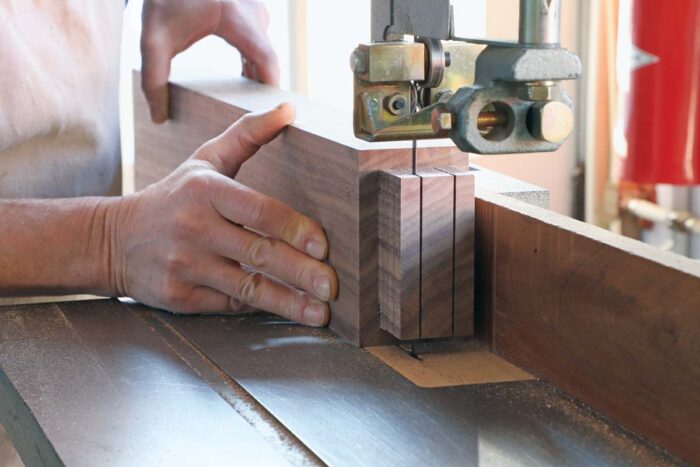 Tom uses the bandsaw to cut the interior shoulders for the double tenon on the leg.