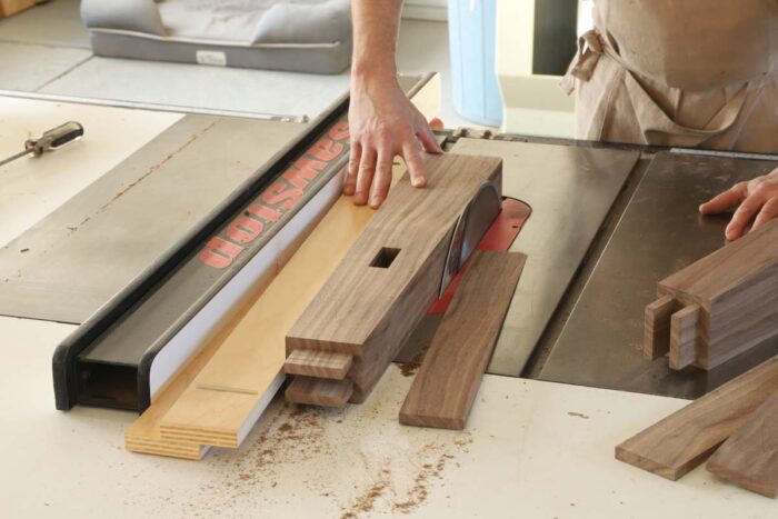 Tom uses the tapering jig to cut the primary angle on the legs. 