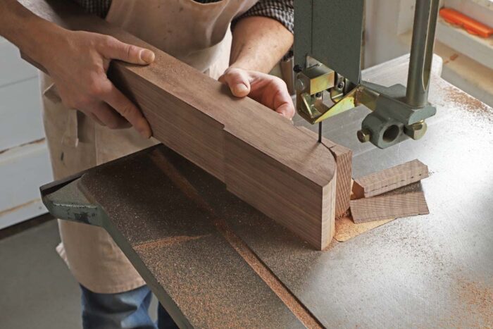 Tom wastes away the edge of the foot on the bandsaw, using the pattern as his guide.