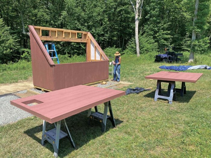 The barn red siding is going on the kiln. The doors are lying on saw horses.