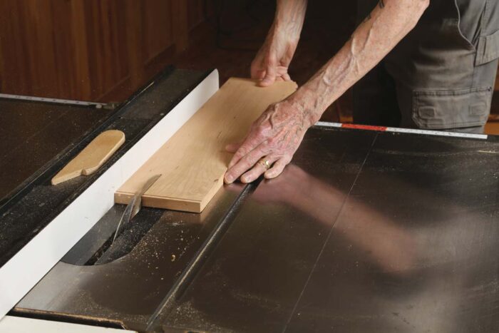 Chris rips the same board into three parts on the table saw.