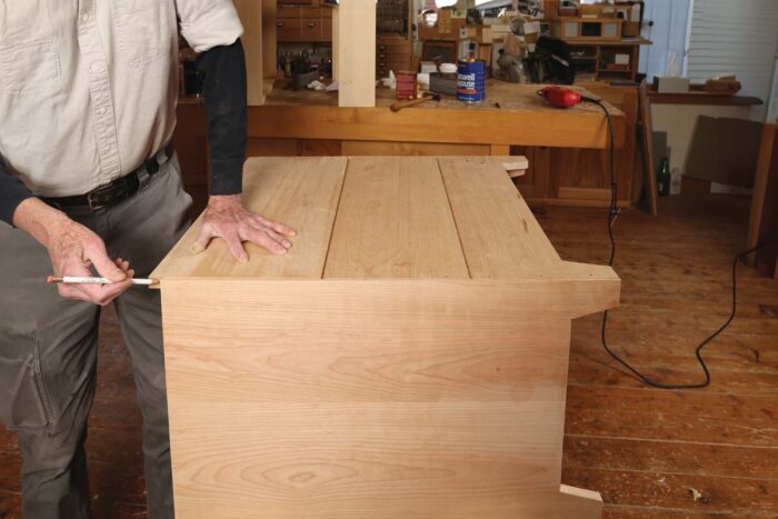 Chris fits the final tongue and groove board to the back of the shaker inspired side chest.