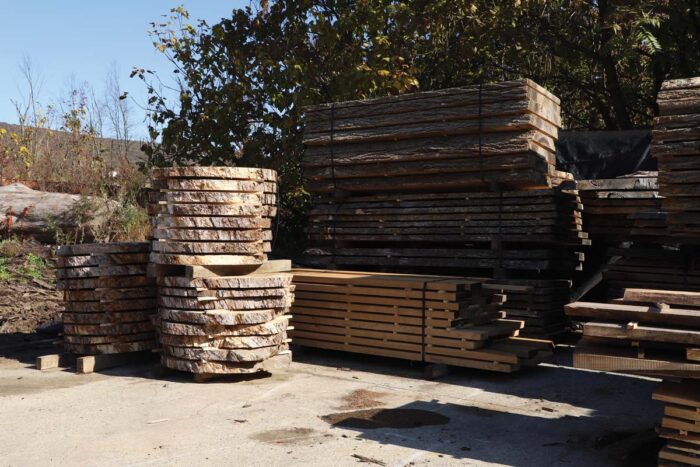 Huge piles of wood drying outside.