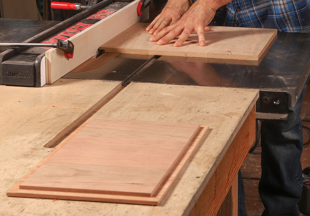 Panels get tongues. A rabbet cut around the perimeter of the side panels produces a tongue sized to fit the grooves in the legs and rails.