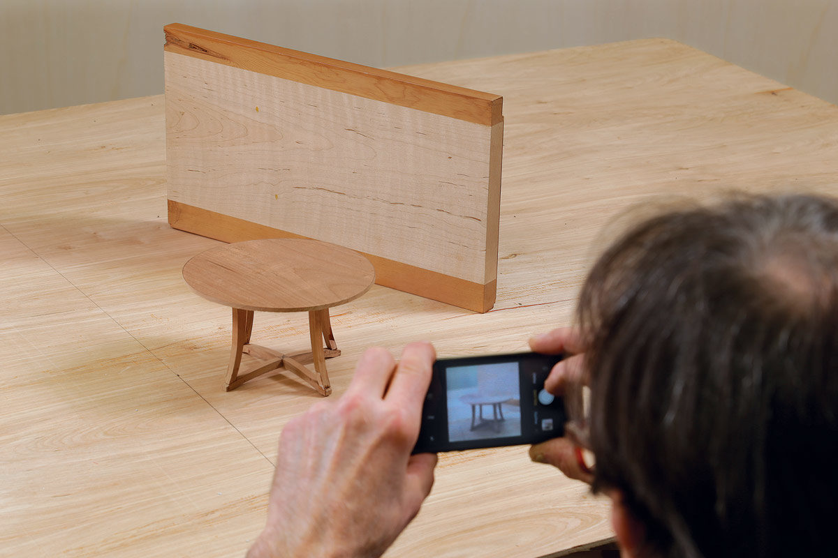 Set up a small environment, with a fake wall and floor, to photograph a scale model.