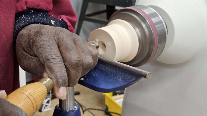 Darryl carves out the center of the jam chuck with a spindle gouge. You can see teeny tiny shavings coming off the tool which is indicative of how little wood he is taking off at a time. 