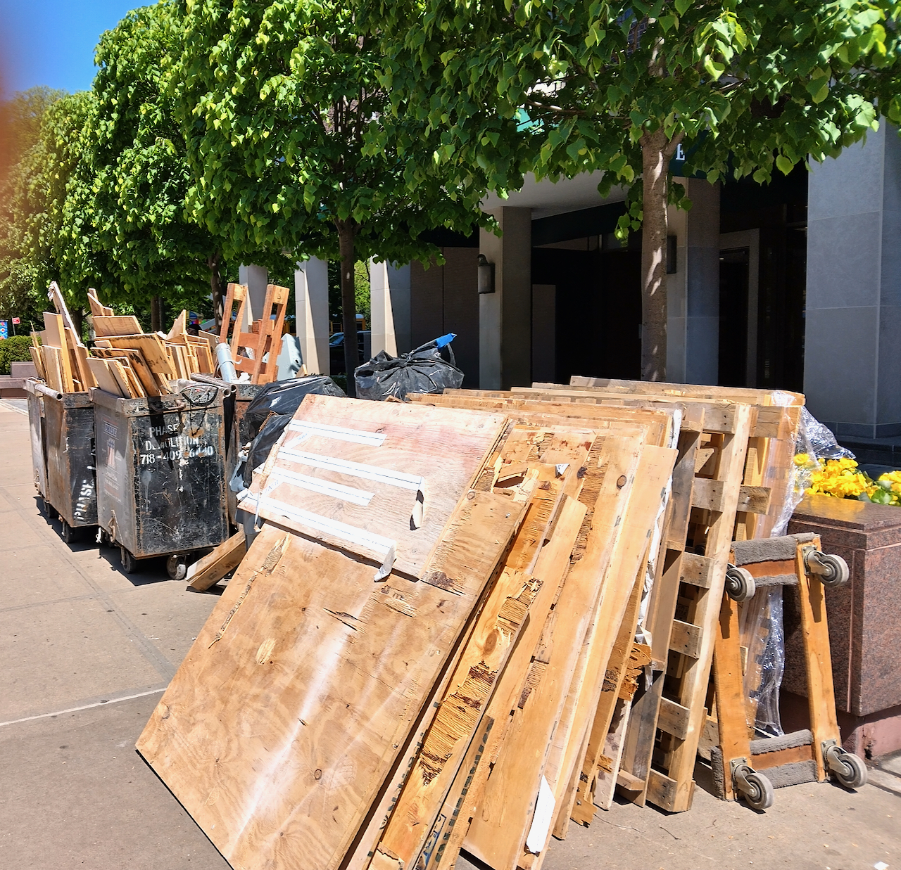 A pile of pallets and wood in a dumpster.