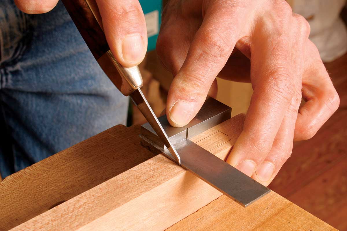 Scribe the ends. To complete the layout, use a knife to scribe a cut line at each end of the mortise.