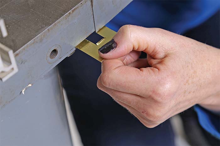 brass shims around the bolts that secure the tabletop to the base